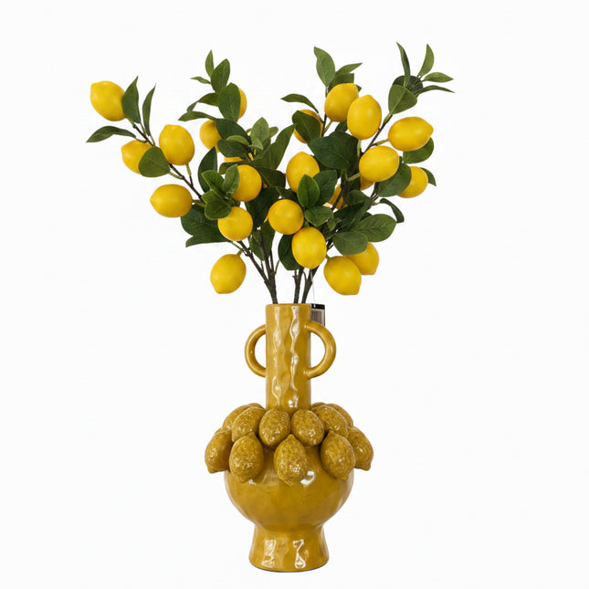 Decorative yellow vase with lemons 